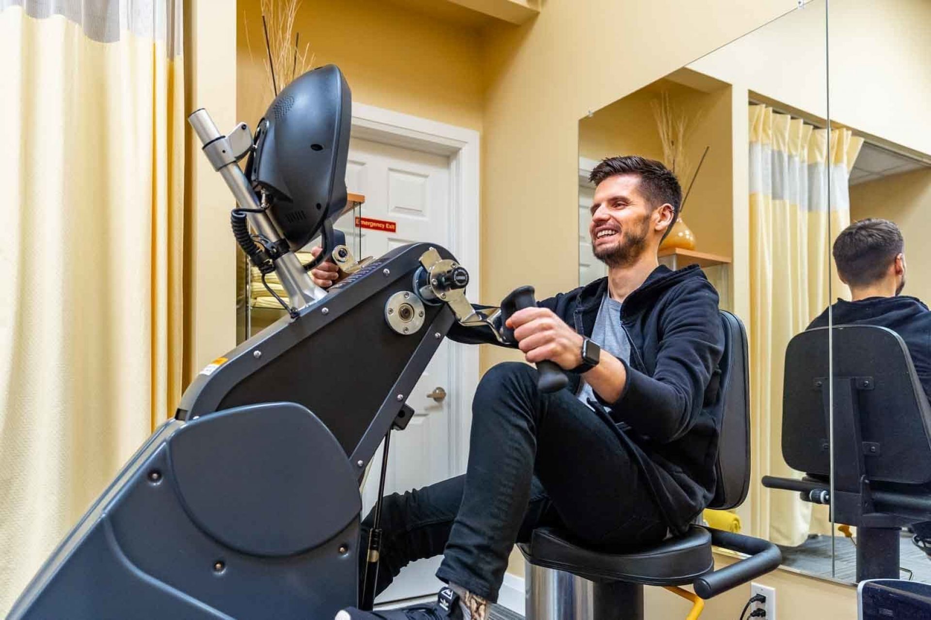 A man rides an exercise bike at Advance Physiotherapy Clinic