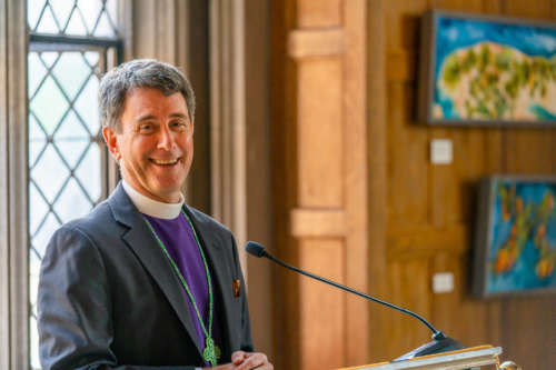 A priest stands at a pulpit